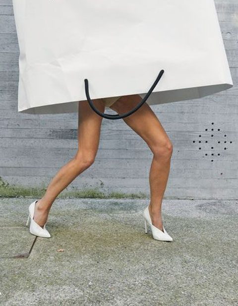 Girl with great legs and head in shopping bag